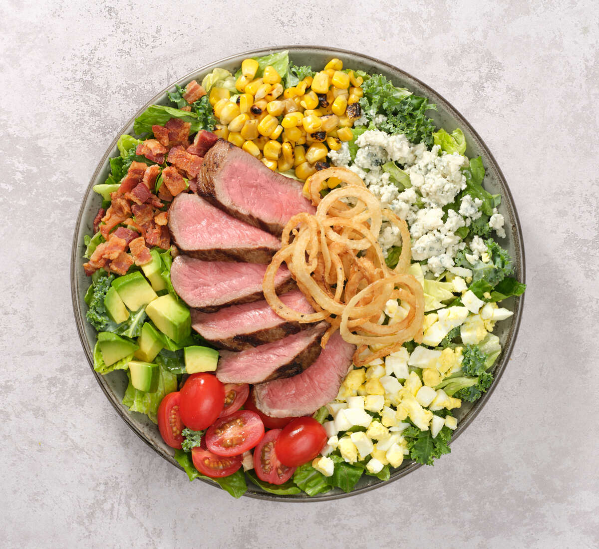 COBB SALAD a plate of salad with meat and vegetables