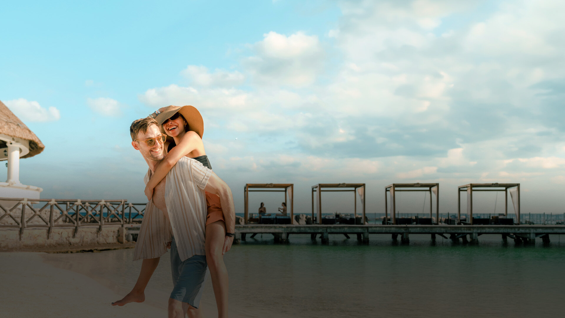 a man holding a woman on a beach