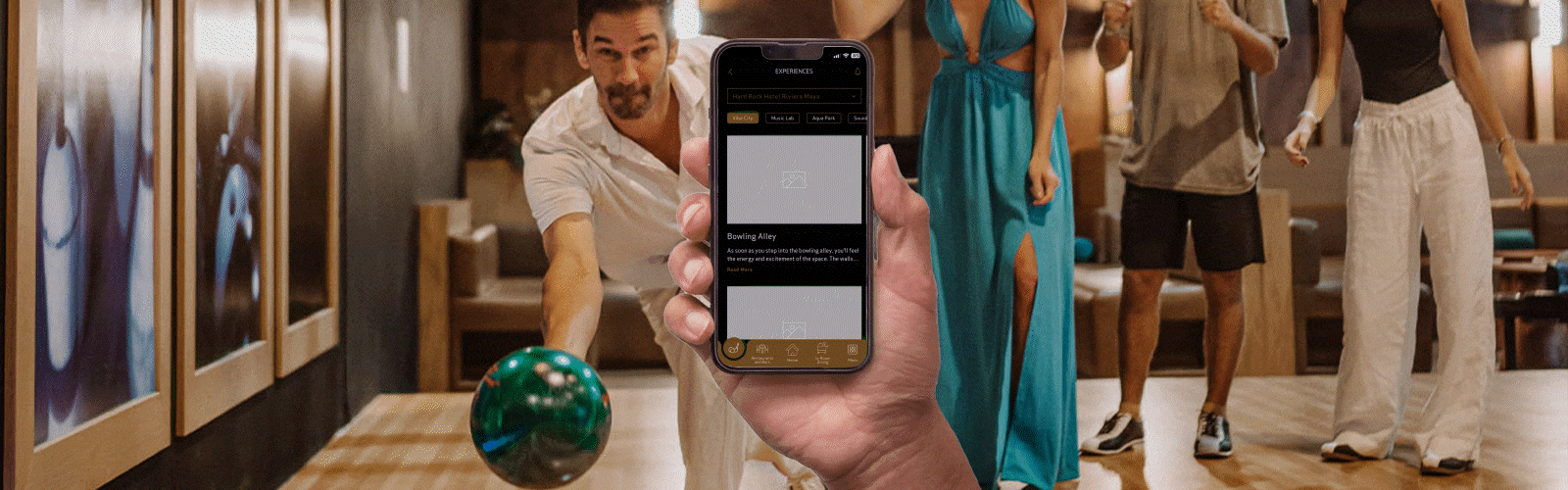 a hand holding a phone with a man bowling in the background
